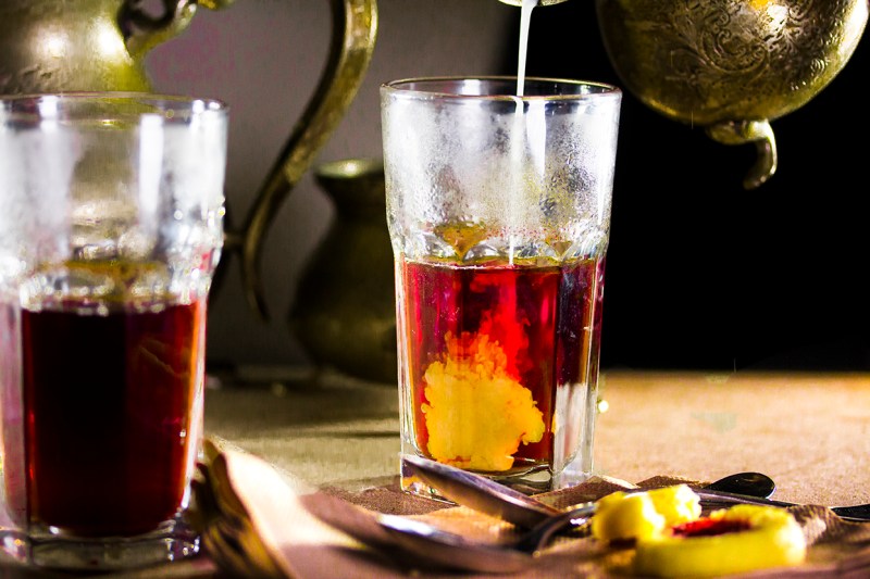 Pouring milk into a hot tumbler of Chai